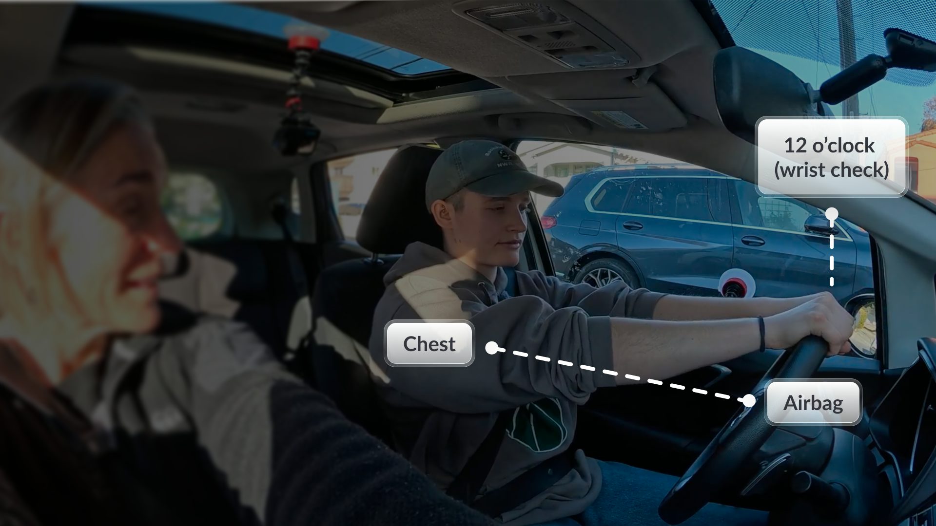 View from behind a teen driver at the wheel with a parent alongside; callouts mark the 12 o'clock wrist check, the chest, and the airbag to show safe seating distance.