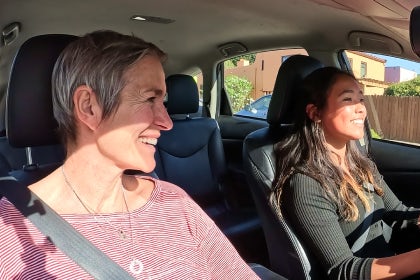 A parent coaching their teen from the passenger seat