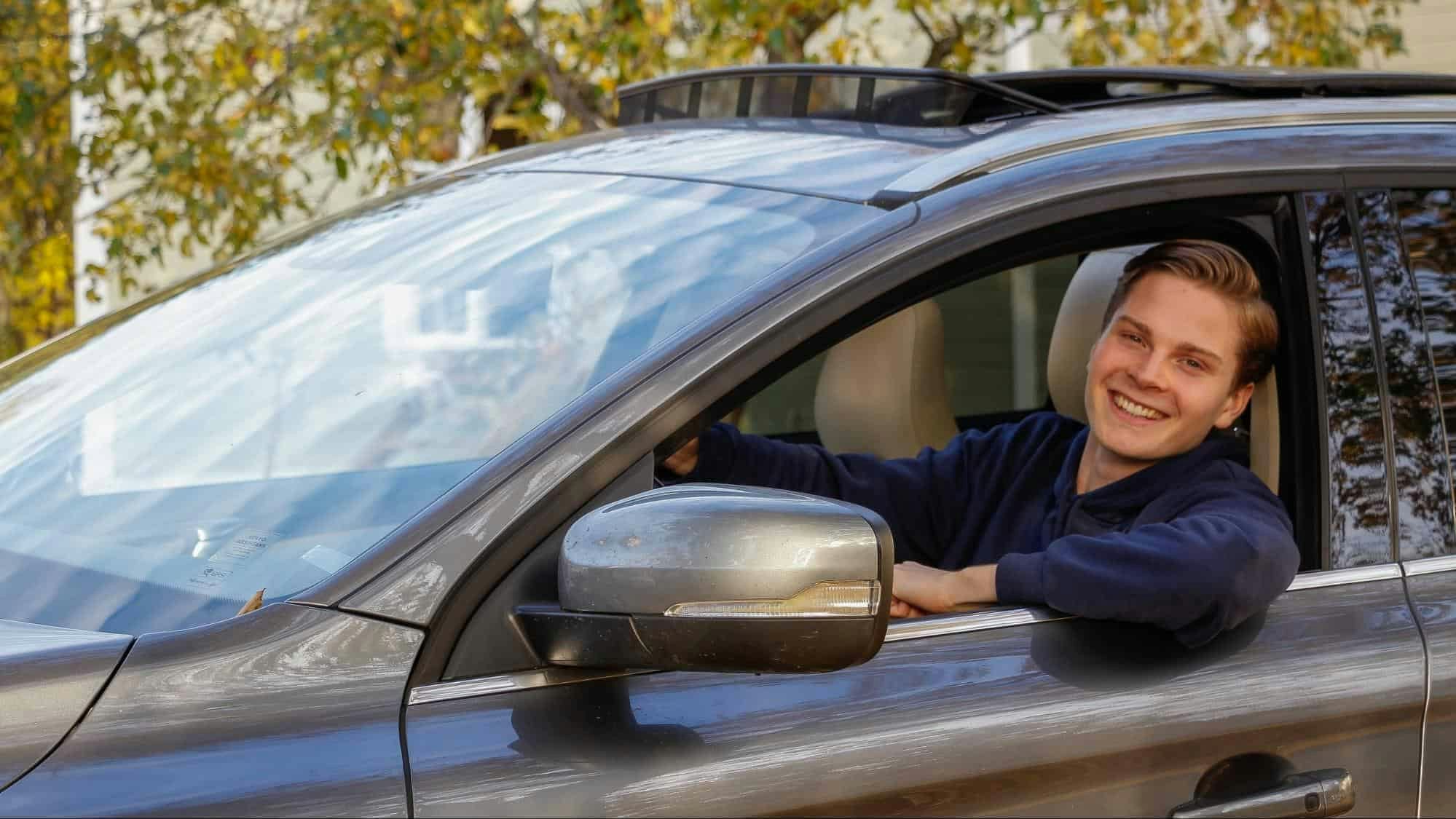 student driver looking through car window