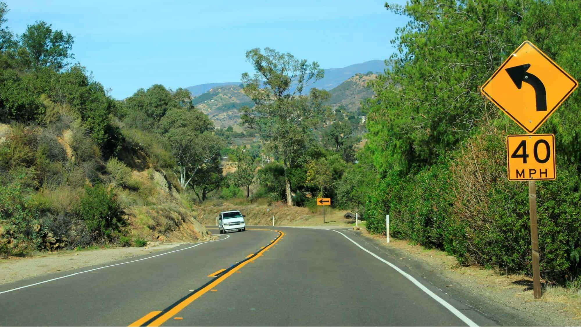 advisory speed limit sign before curve