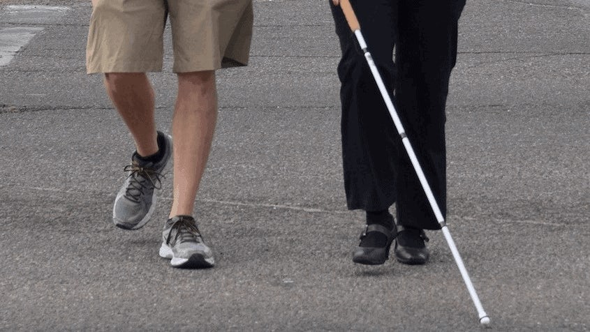 a blind person crossing the street