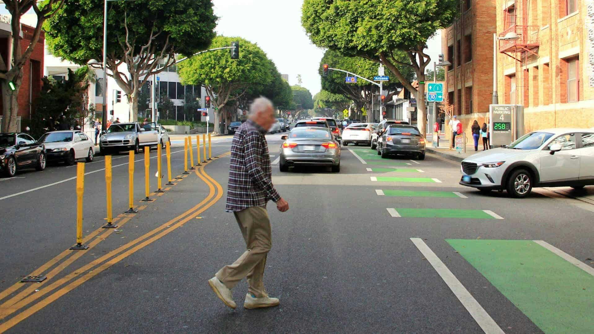 Elderly pedestrian crossing the street at an at an unsuitable crossing point