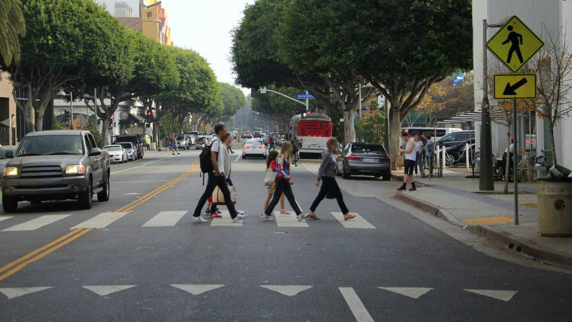 A group of young people at a marked crosswalk 