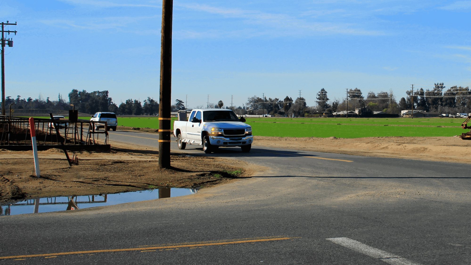 truck at intersection signaling a right turn