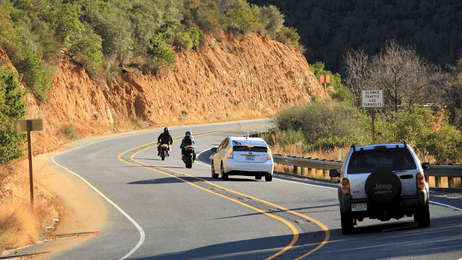 ‘Slower traffic use turnouts’-sign on the side of the road