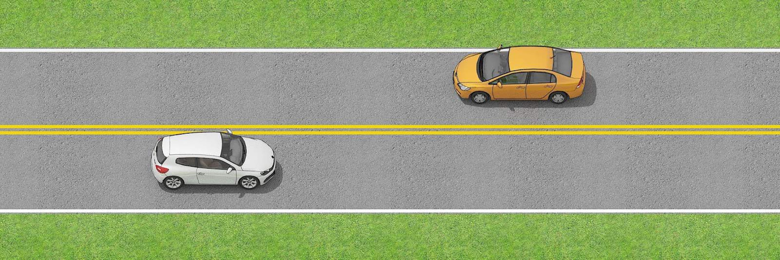 Two vehicles separated by double solid yellow lines