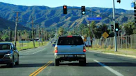 Car waiting in front of a red traffic light arrow and green traffic light