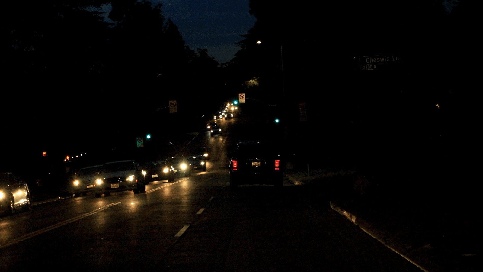 car driving on busy road with oncoming cars at night
