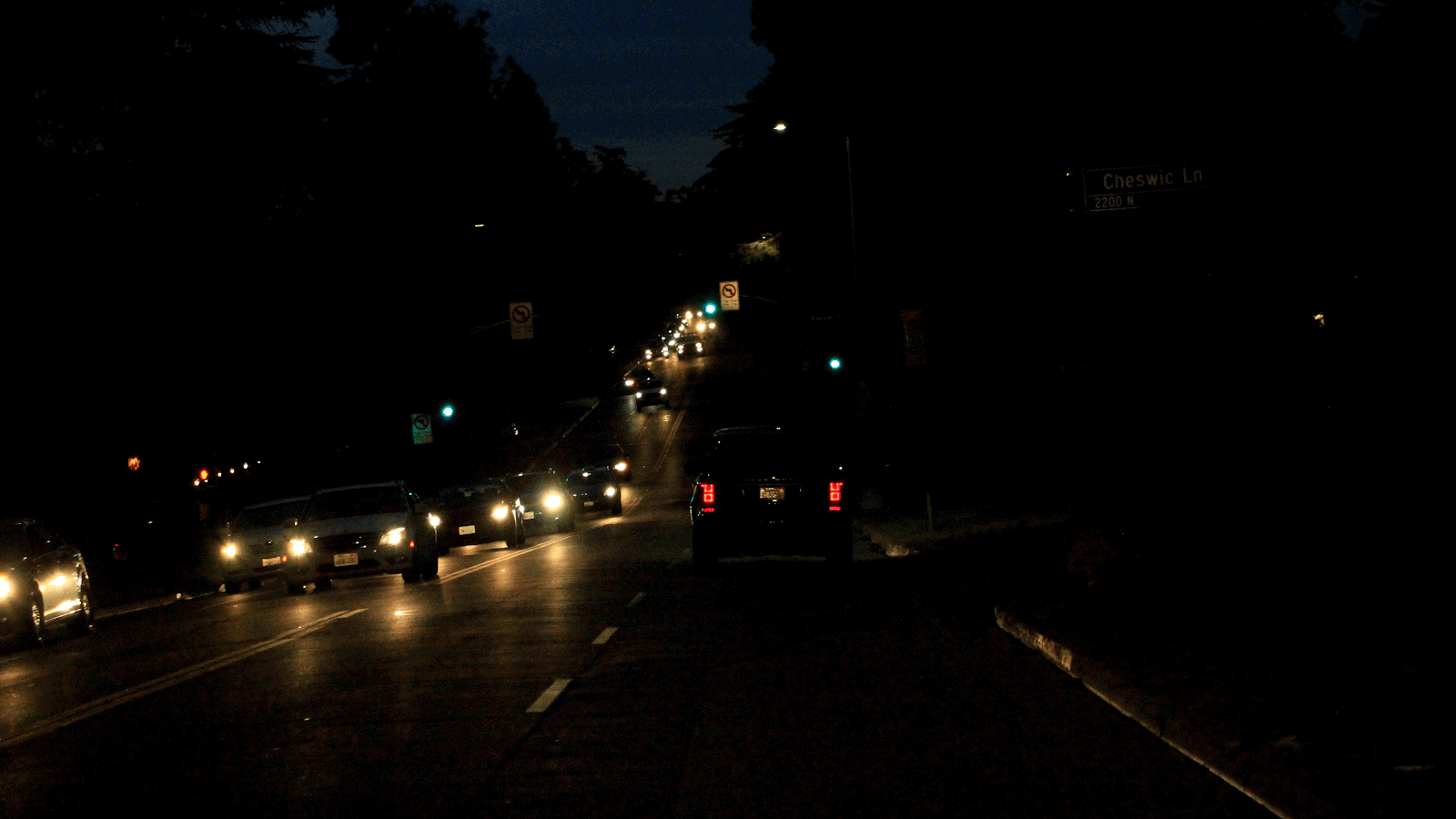 car driving on busy road with oncoming cars at night 