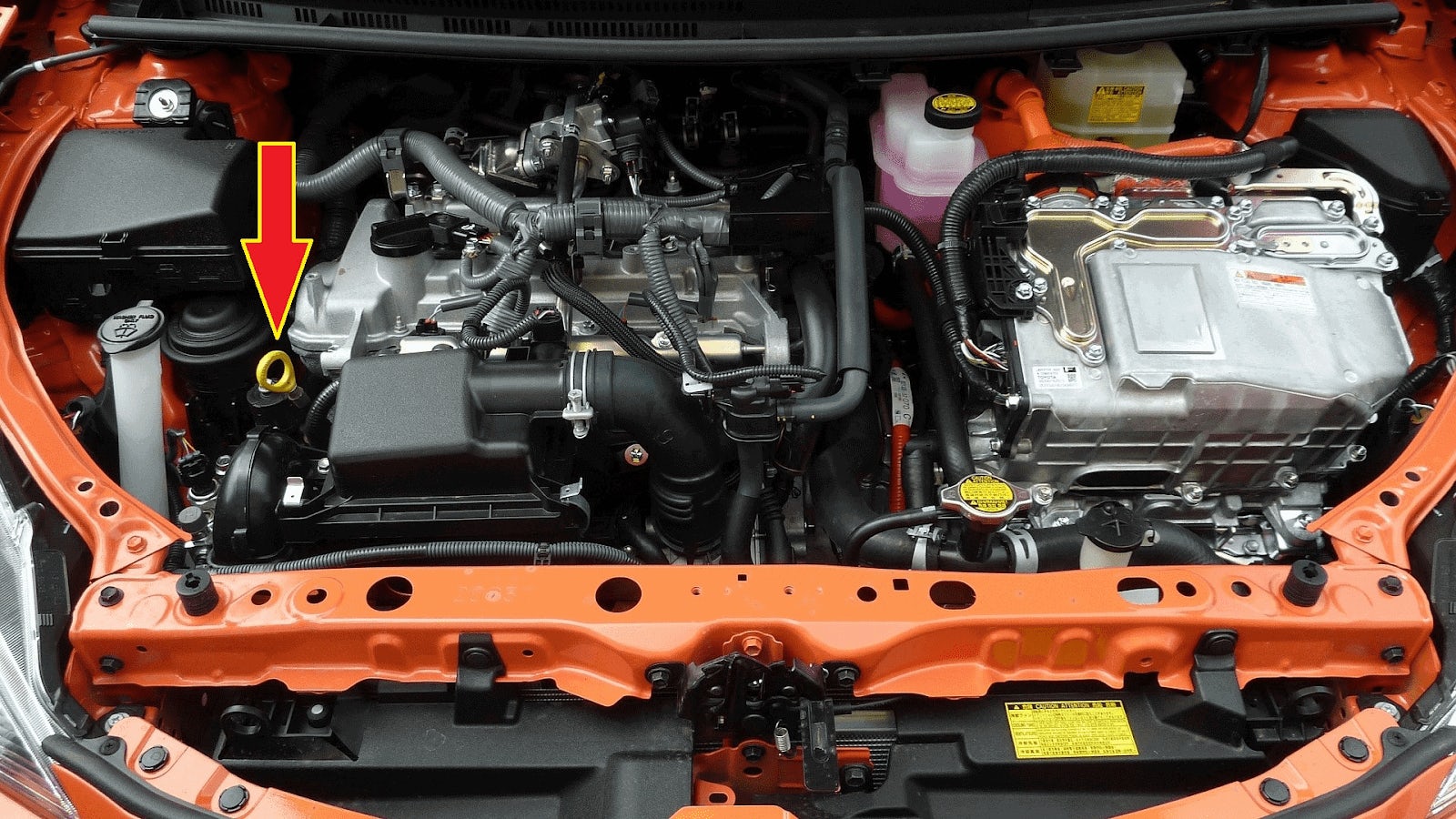 The yellow ring indicated by the red arrow is the oil dipstick