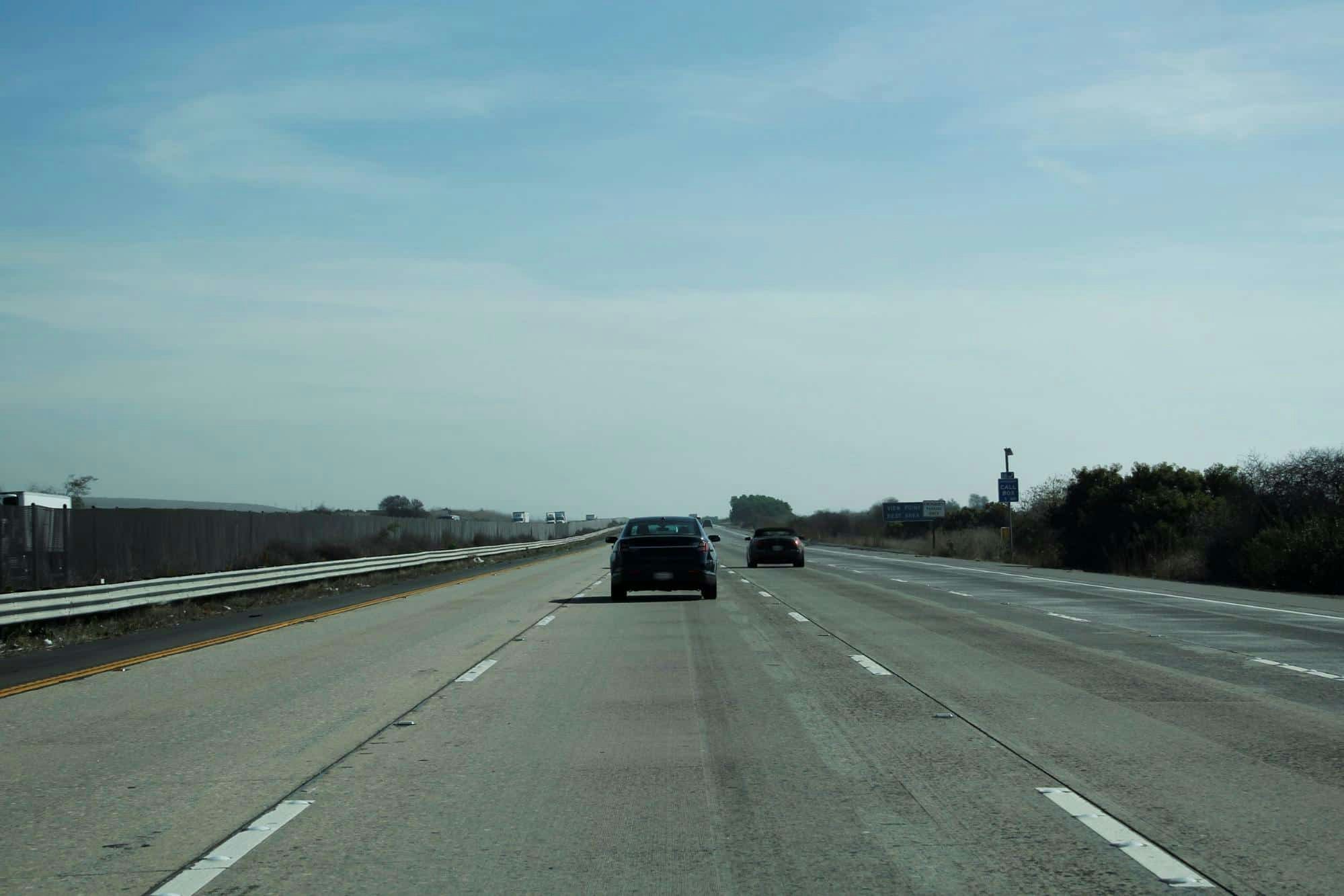 cars driving on a freeway with little traffic