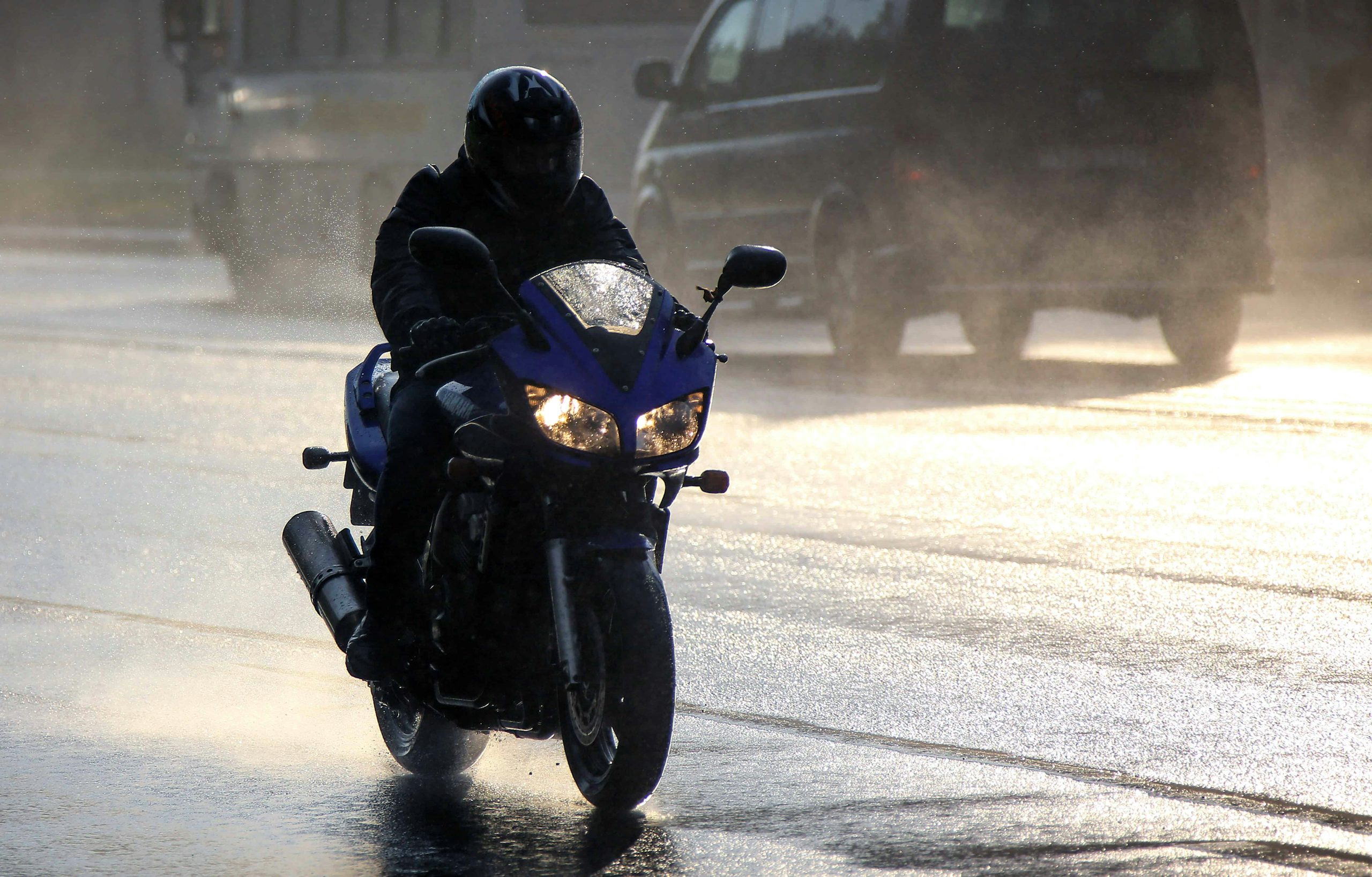 Motorcyclist riding in bad weather