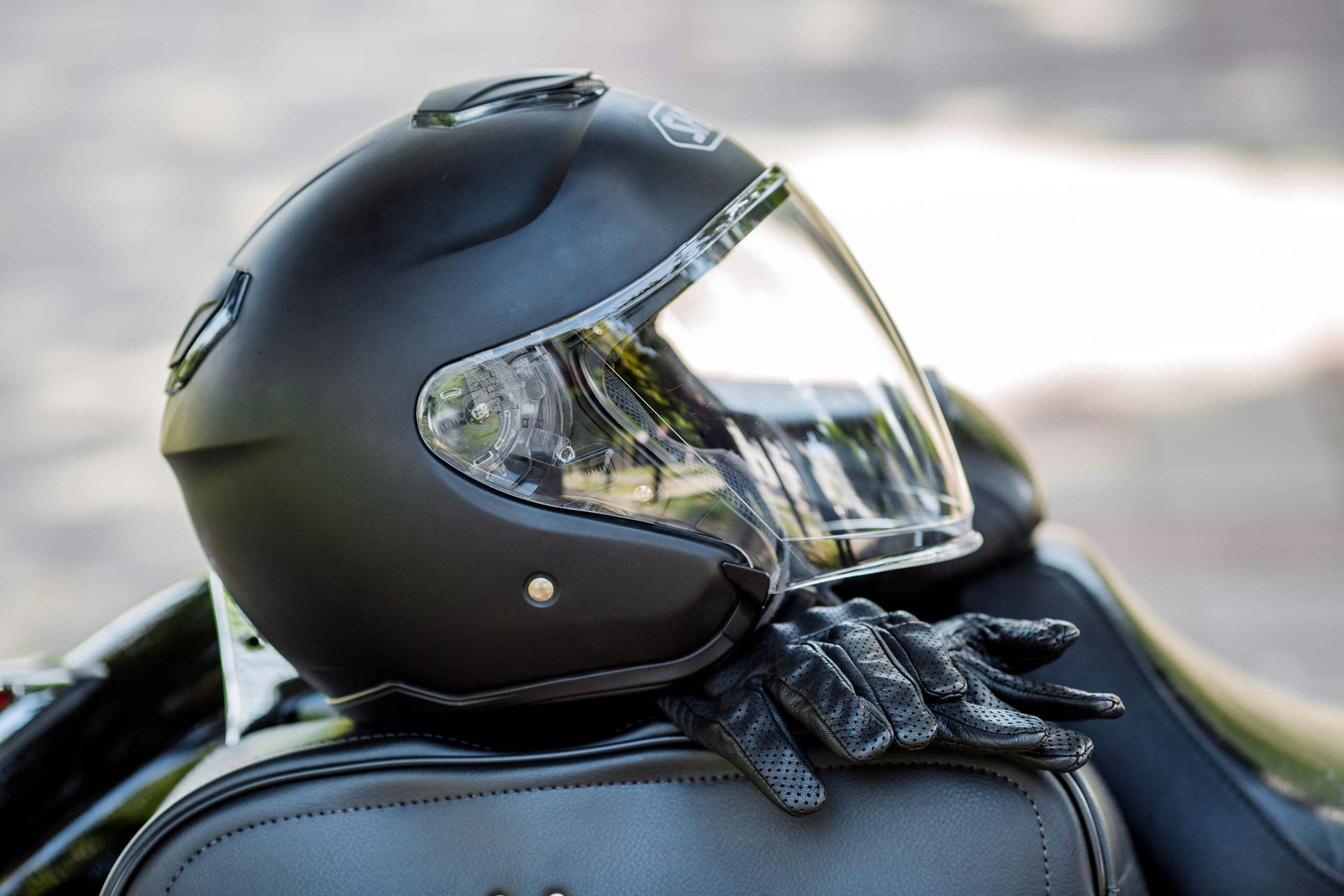 Motorcycle gear on top of a black leather bag