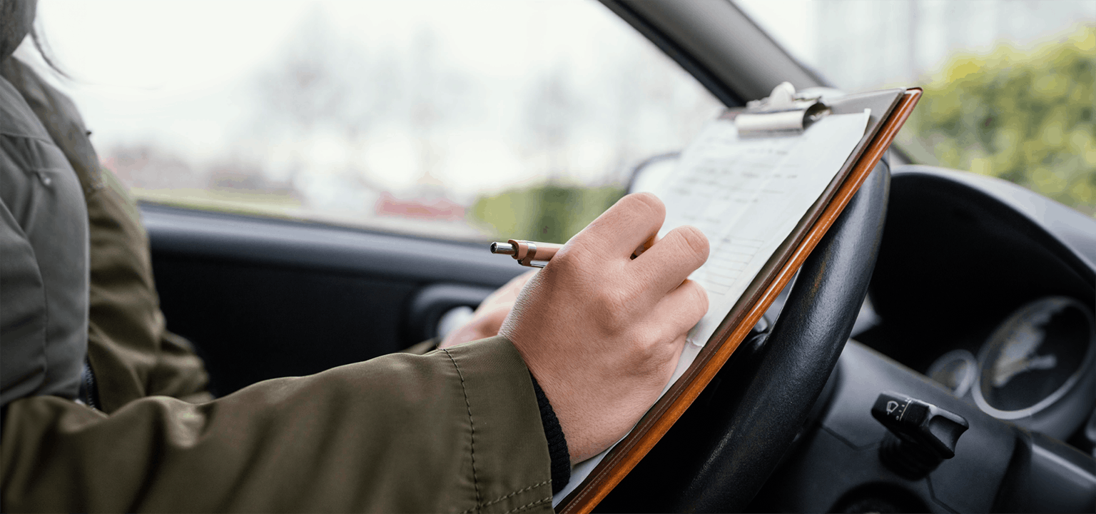 hand on the clipboard in the car