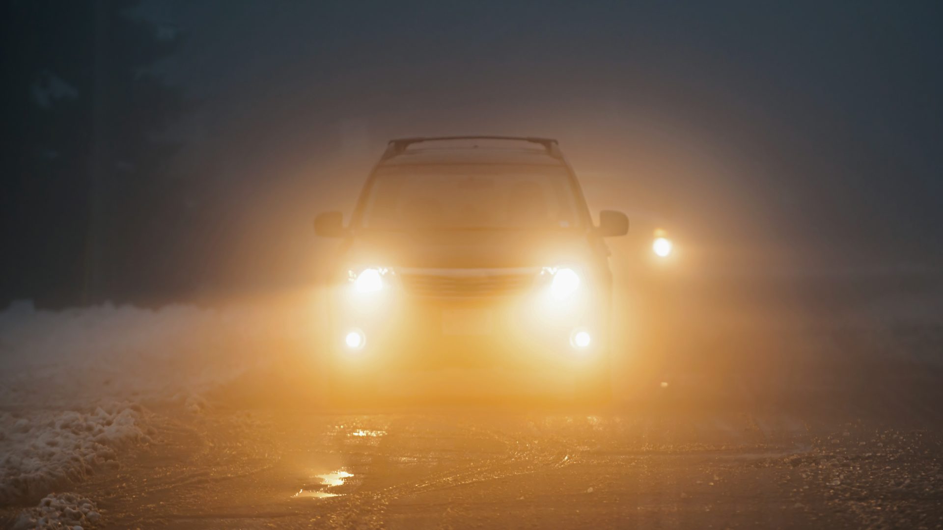 car with fog lights on at night