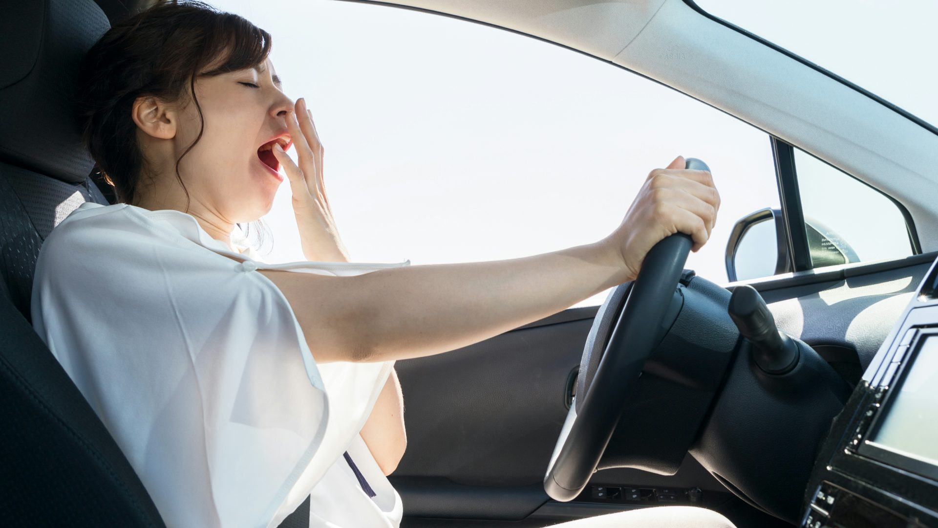 driver yawning behind the wheel