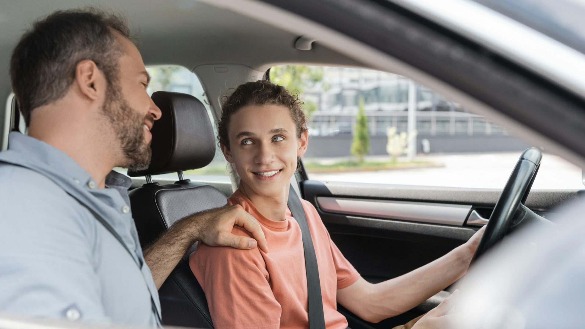 photo of a teen driver with a parent in the car