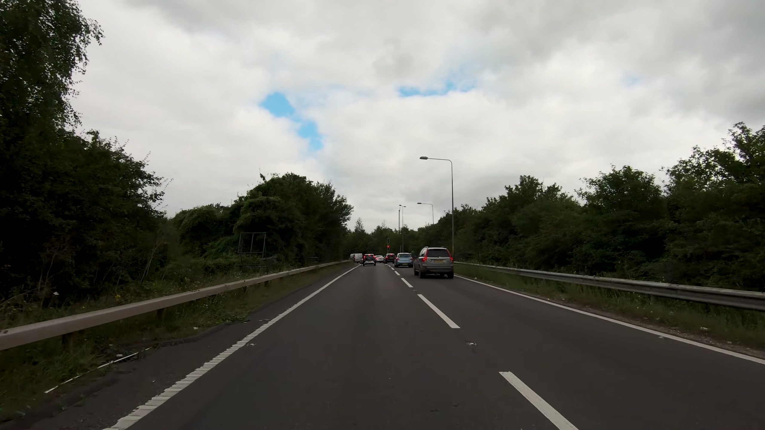 Stopped traffic ahead in front of a red traffic light.