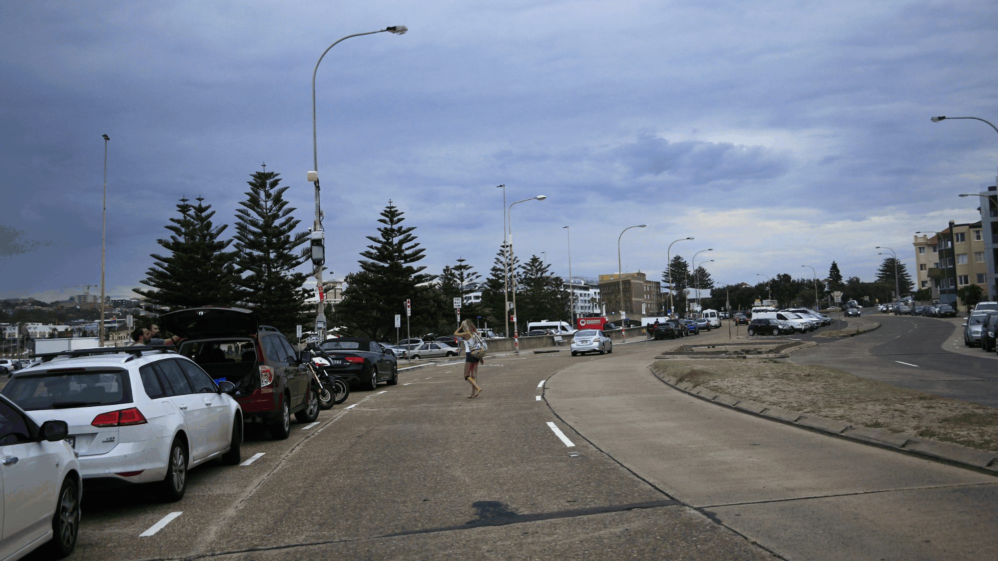 People can walk out from behind cars